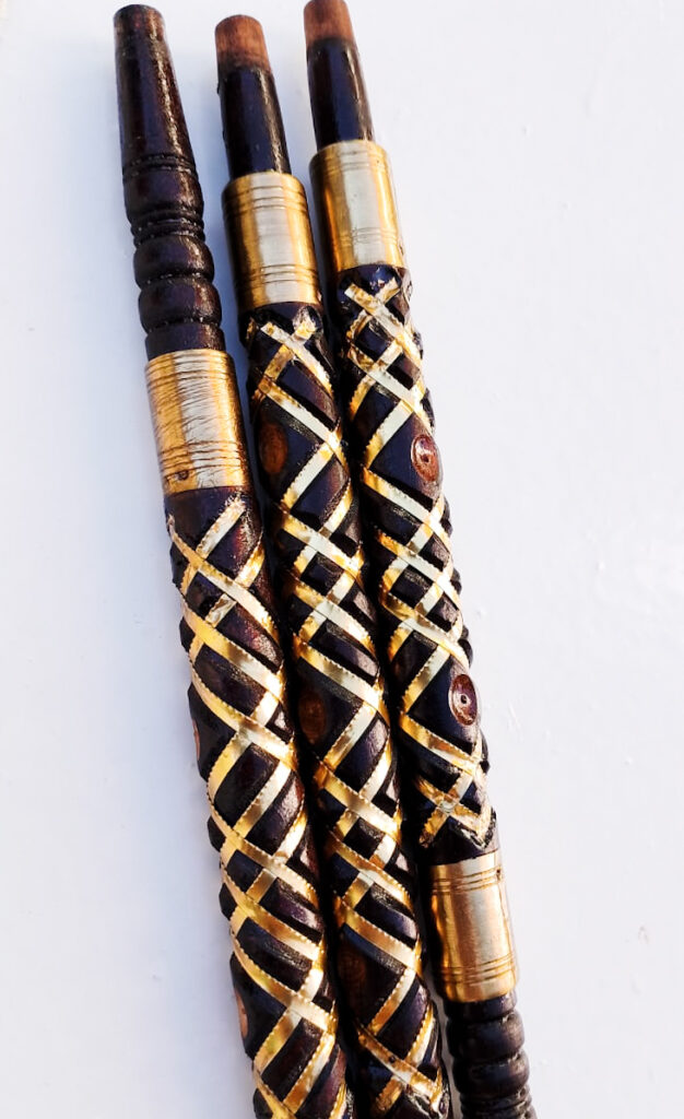 Black sebsi stem inlaid with a cream bone lattice and gold thread