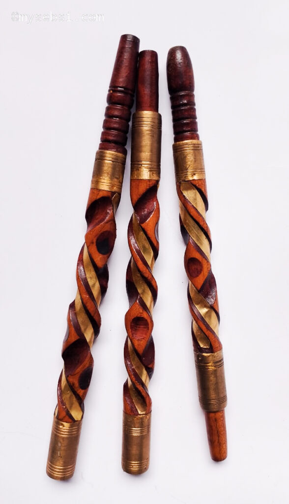 Three copper-toned spiral-carved sebsi pipes with brass tips